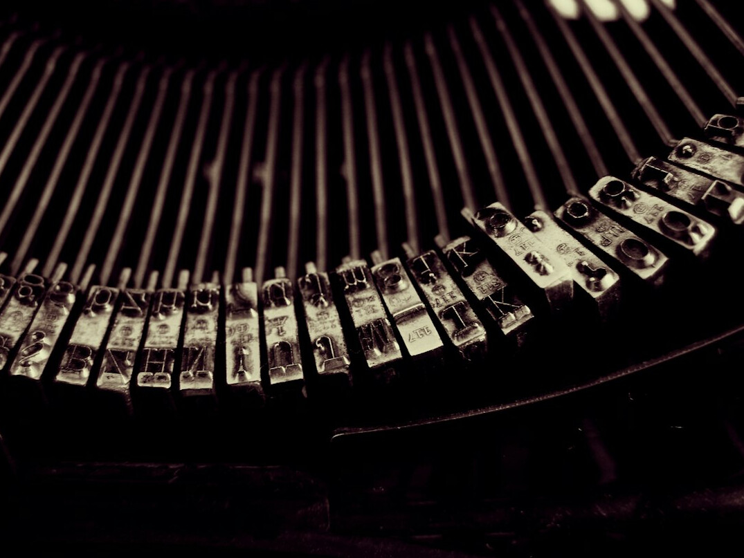 writer typing on old typewriter