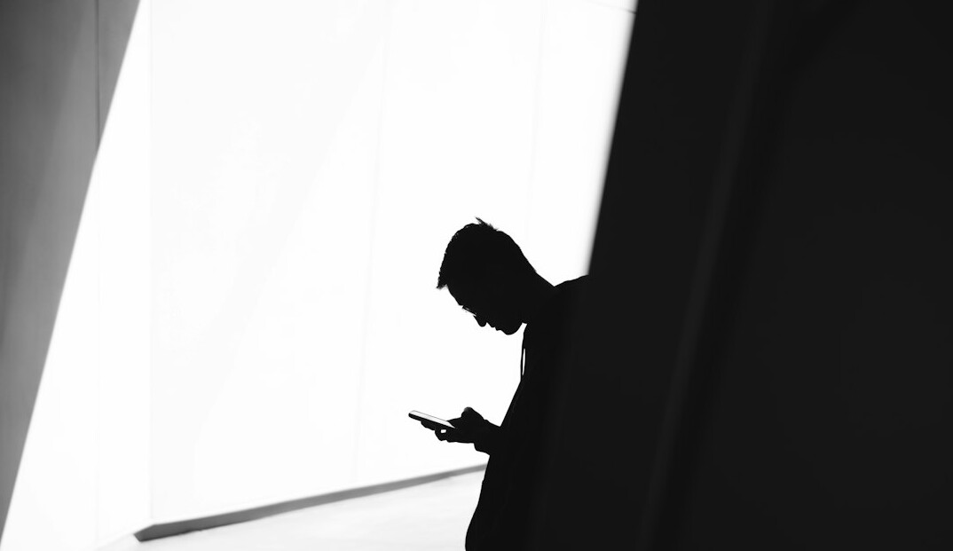 person thinking in shadows